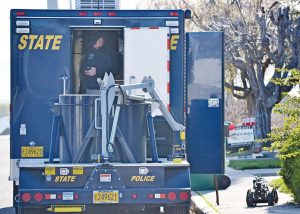 Oregon State Police detectives use a small robot to examine a suspicious object inside a taped-up coffee can. Upon investigation, it was determined that the can contained a Dewalt power tool battery and nothing else.