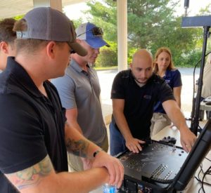An industry partner explains a camera display for a robotic dog
